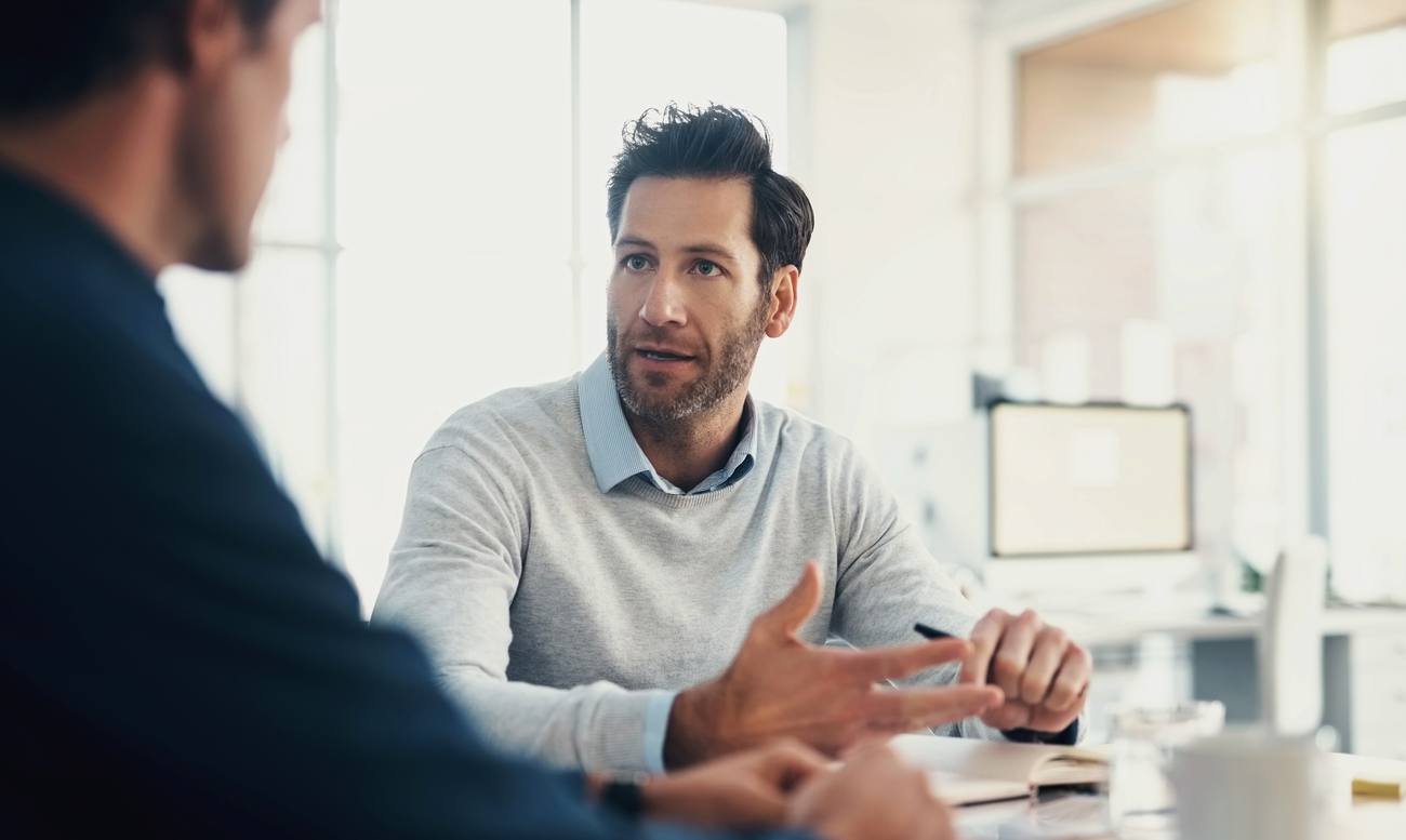 Two people in conversation across a table