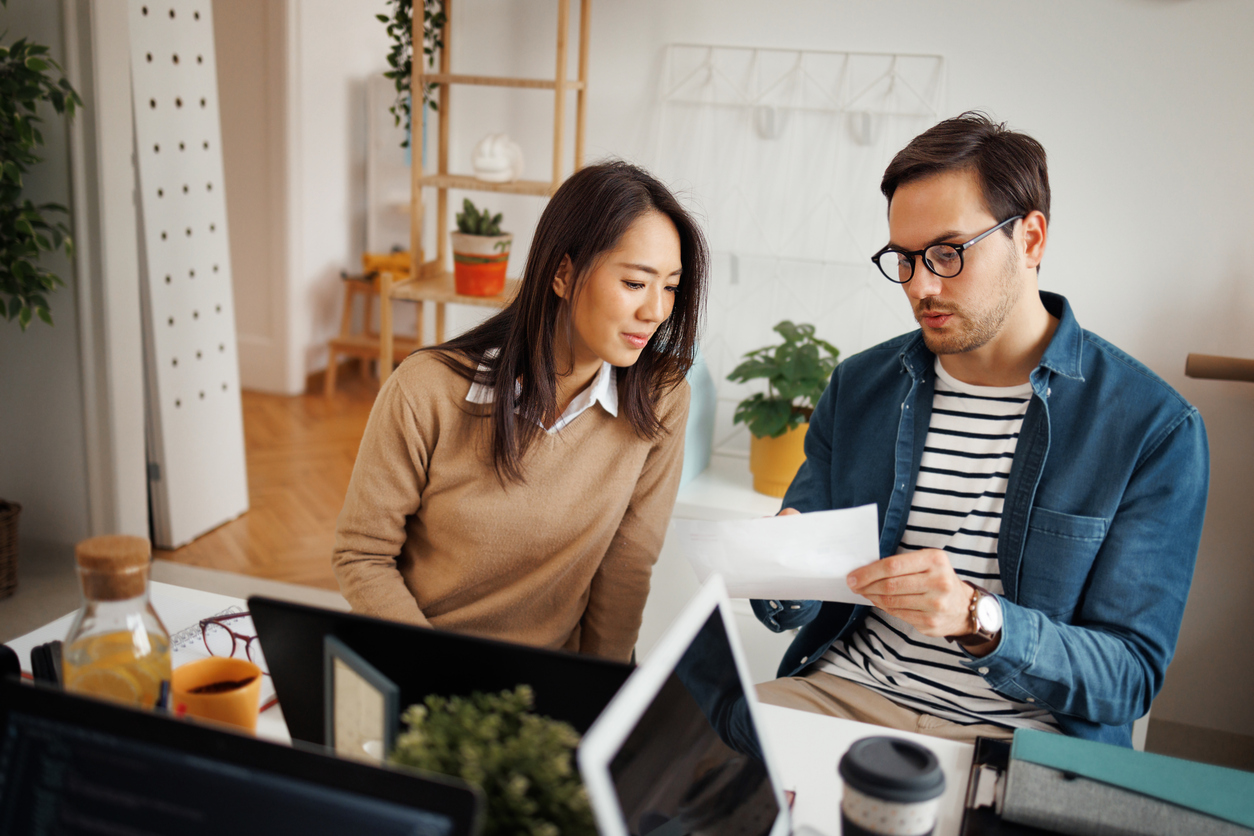 Two people reviewing a deal document together at a desk
