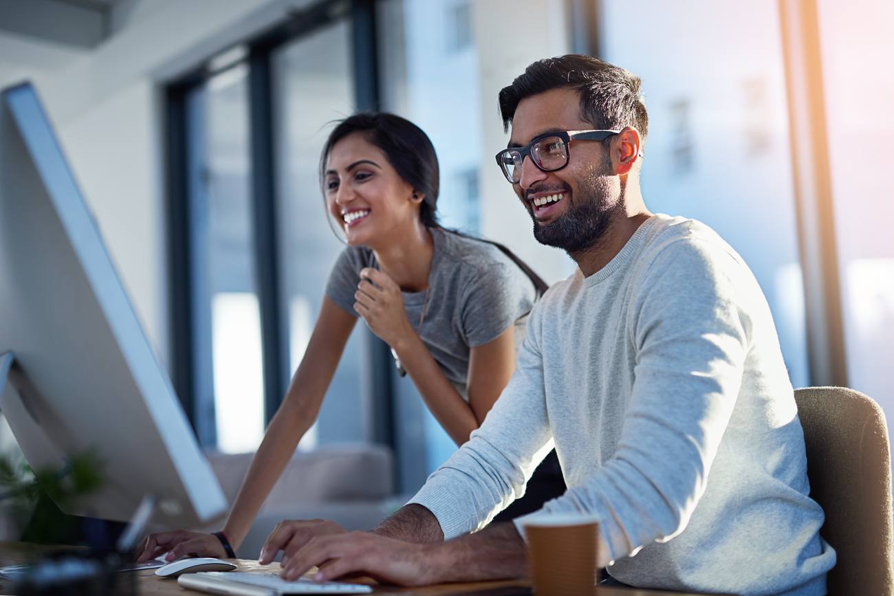 Two people working through a deal at a desk